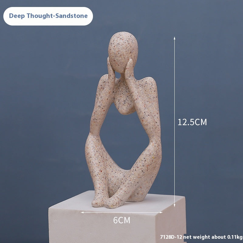 Coppia sculture oro corpi accovacciati