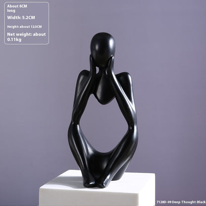 Coppia sculture oro corpi accovacciati