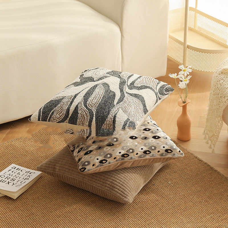 Copricuscino beige con motivo floreale