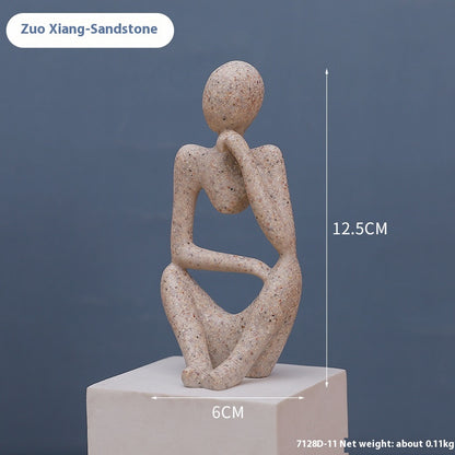 Coppia sculture oro corpi accovacciati