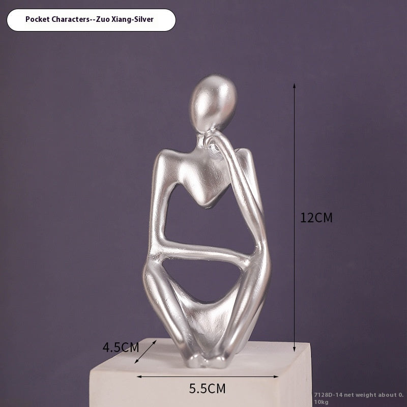 Coppia sculture oro corpi accovacciati