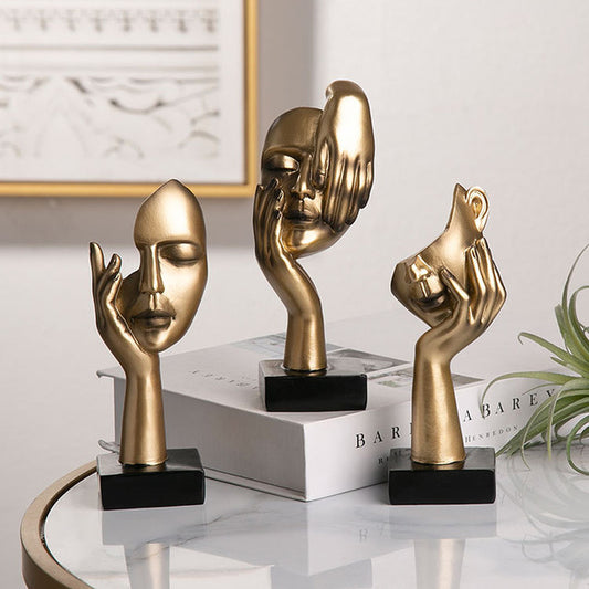 Sculture volti dorate emozioni tre